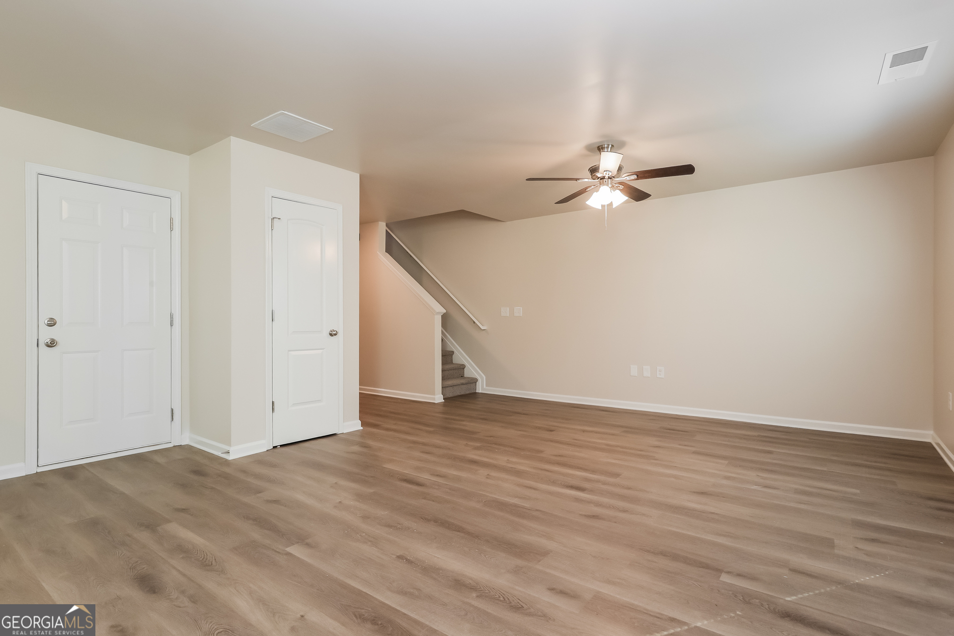 20 Sloane Court Covington, GA 30016 - Photo 2 of 16 wooden floor in an empty room with a ceiling fan