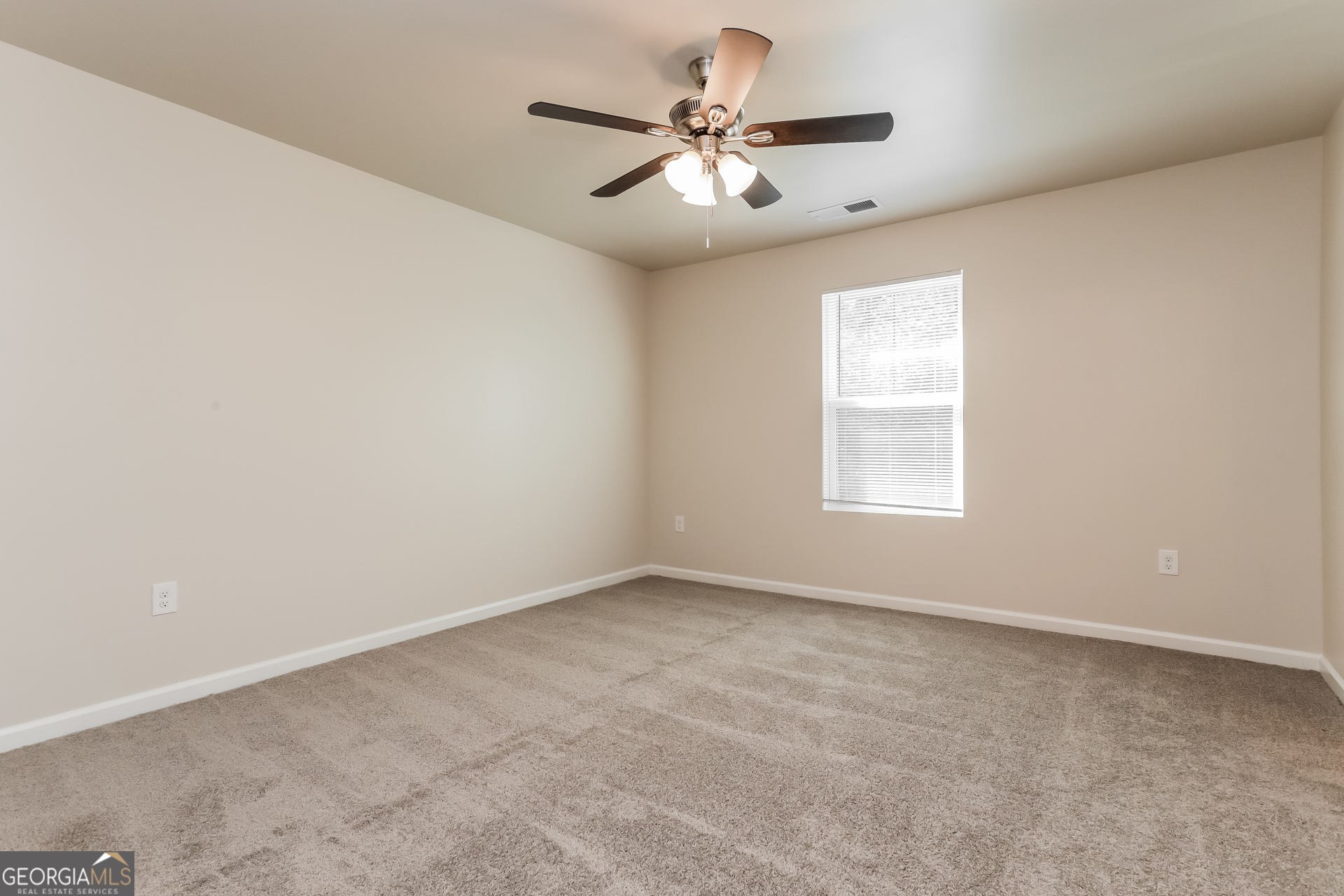 20 Sloane Court Covington, GA 30016 - Photo 7 of 16 an empty room with windows and ceiling fan