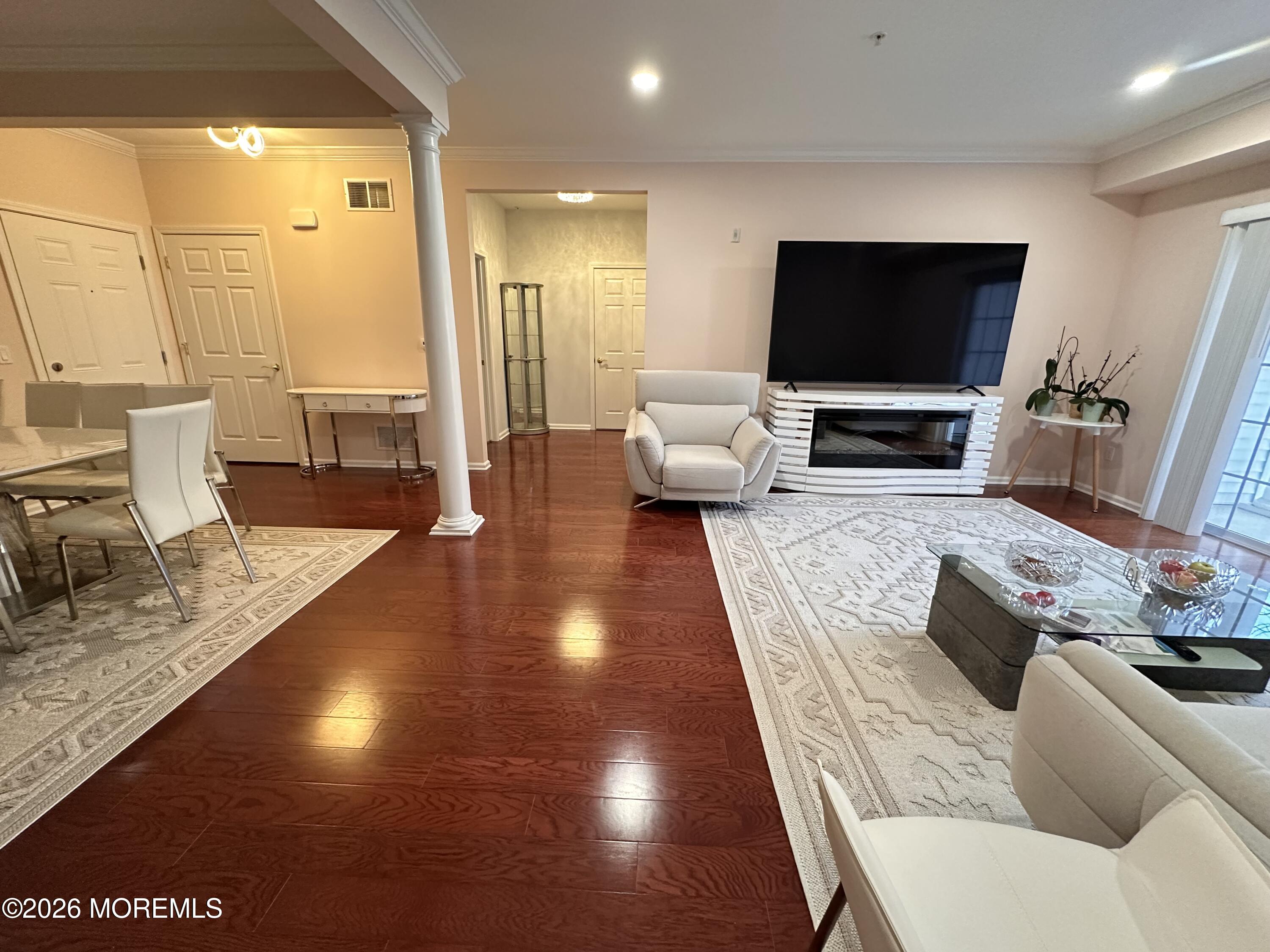 112 Regency Court Morganville, NJ 07751 - Photo 11 of 69 a living room with furniture and a flat screen tv