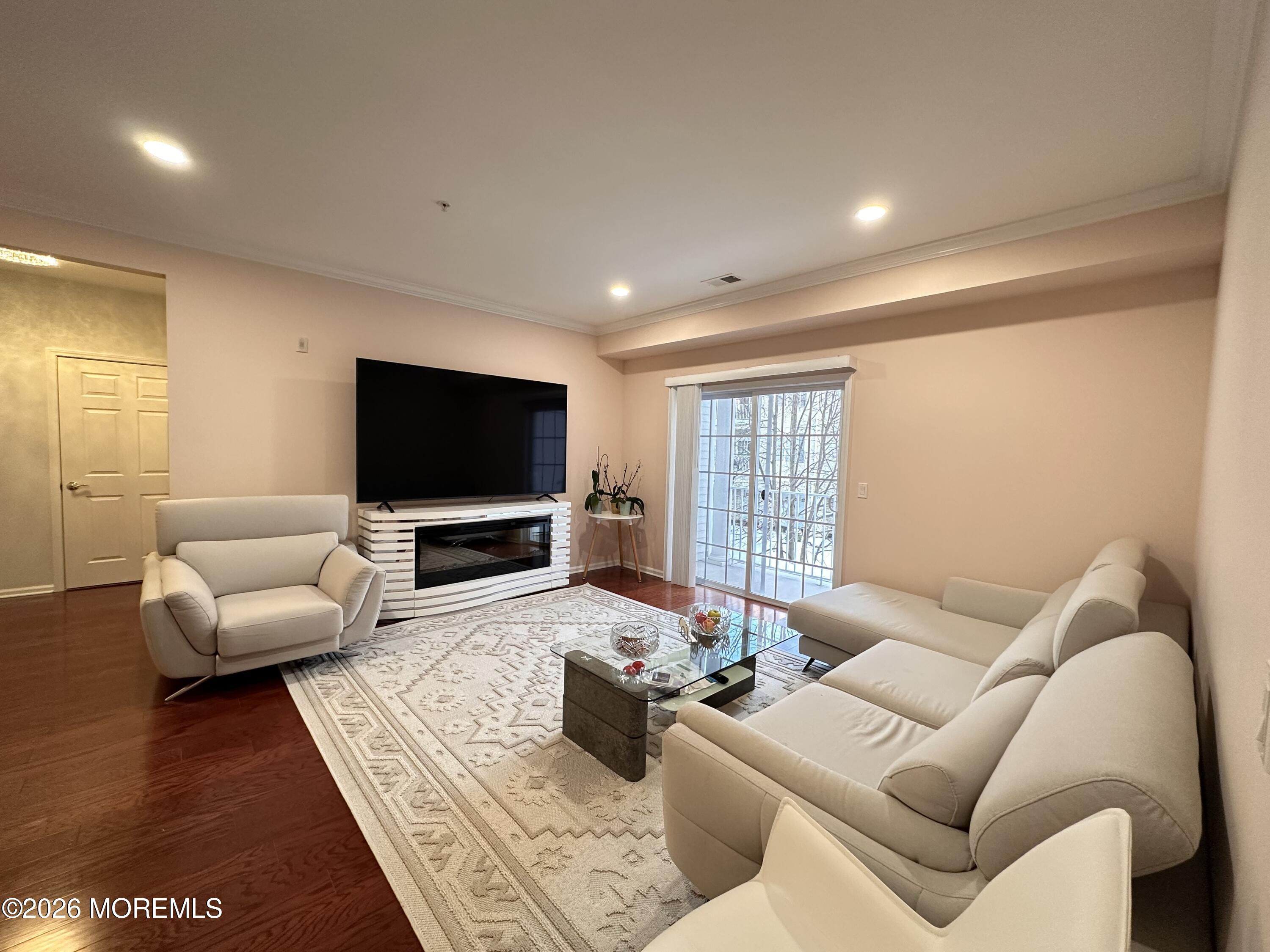 112 Regency Court Morganville, NJ 07751 - Photo 12 of 69 a living room with furniture and a flat screen tv