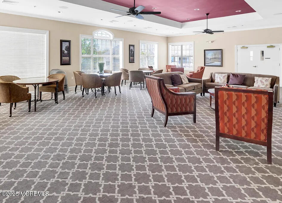 112 Regency Court Morganville, NJ 07751 - Photo 20 of 69 a living room with furniture a large window and chandelier