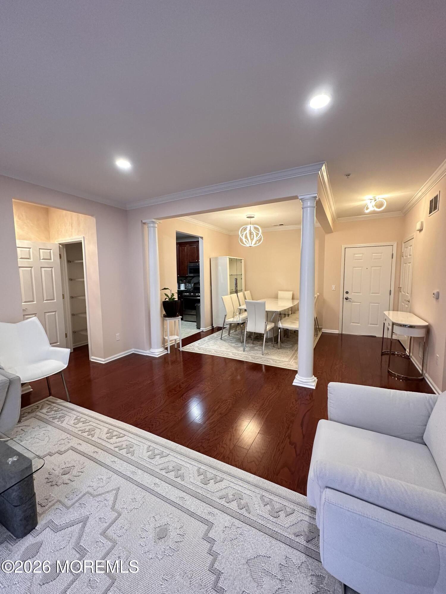 112 Regency Court Morganville, NJ 07751 - Photo 22 of 69 a living room with furniture and a large window