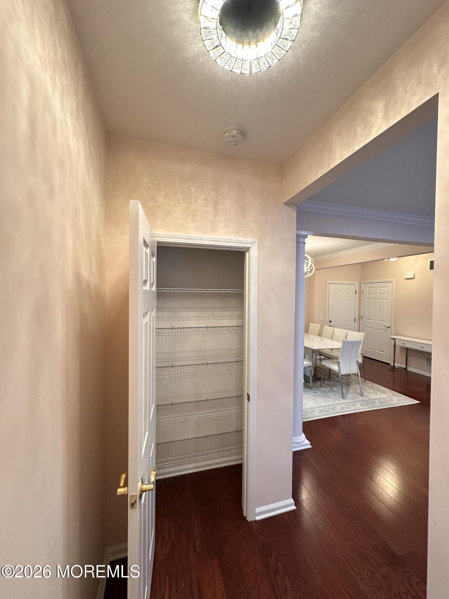 112 Regency Court Morganville, NJ 07751 - Photo 28 of 69 a view of empty room with wooden floor