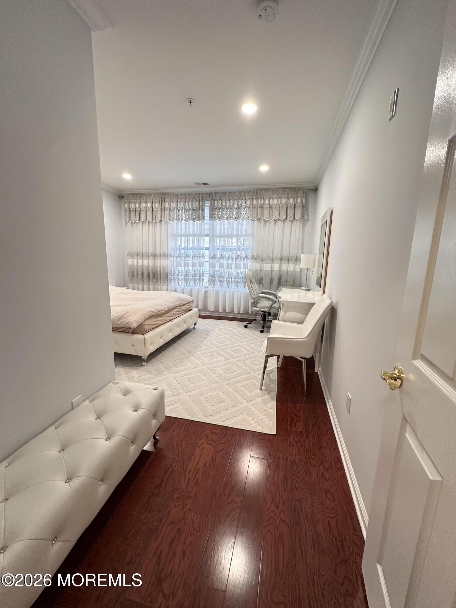 112 Regency Court Morganville, NJ 07751 - Photo 29 of 69 a living room with furniture and a wooden floor