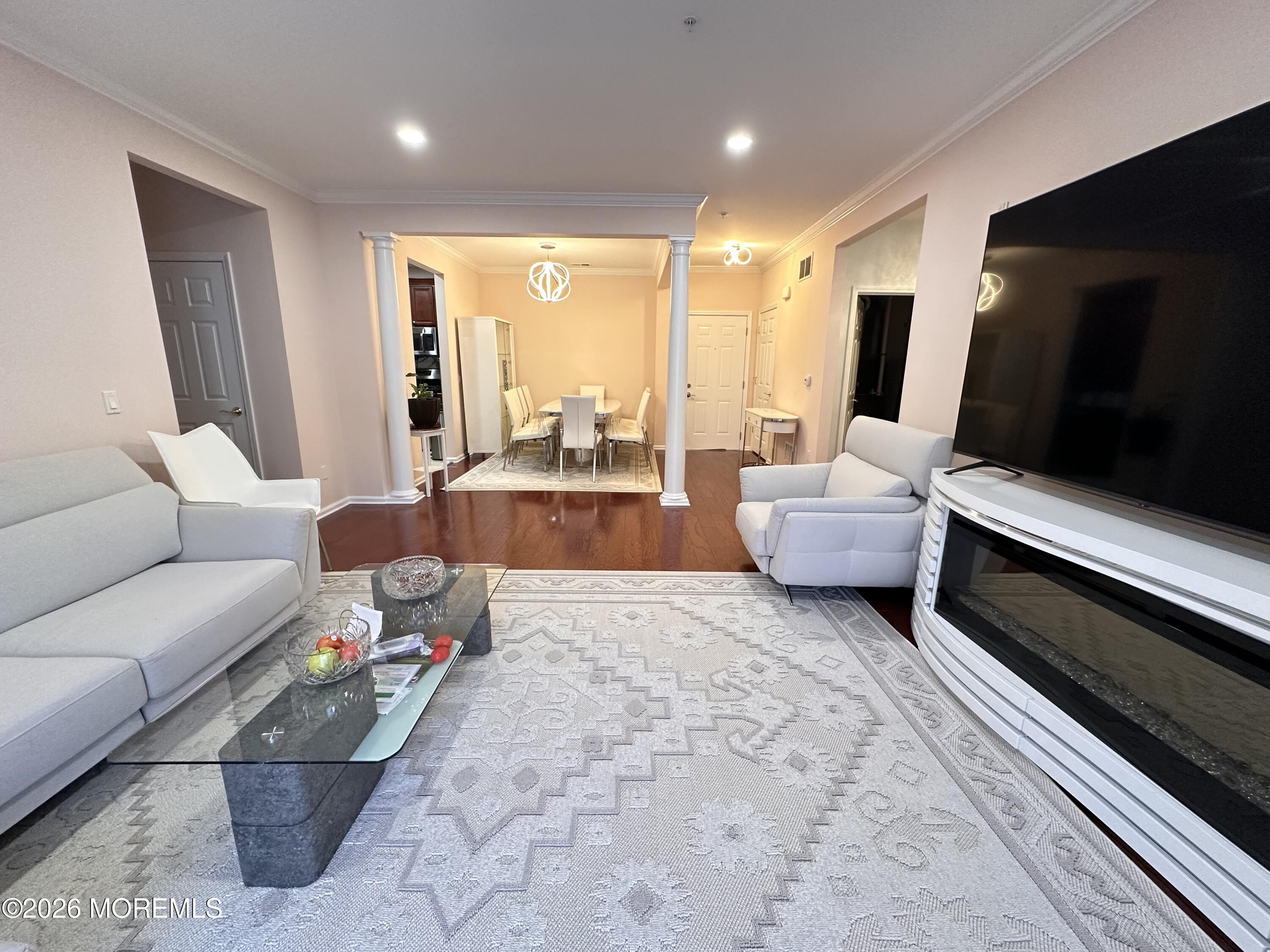 112 Regency Court Morganville, NJ 07751 - Photo 4 of 69 a living room with furniture and a flat screen tv