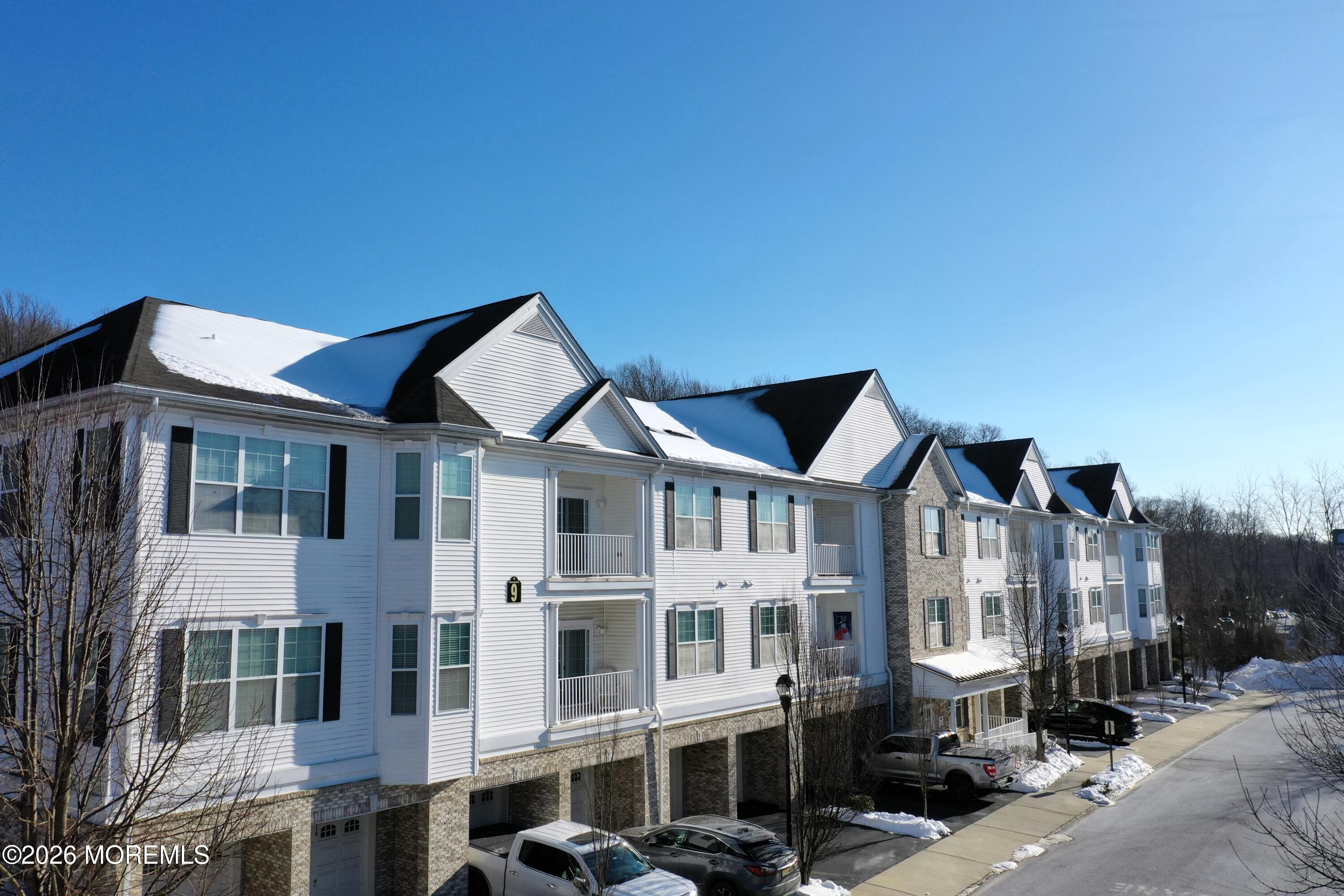 112 Regency Court Morganville, NJ 07751 - Photo 62 of 69 a front view of a building with streets and trees
