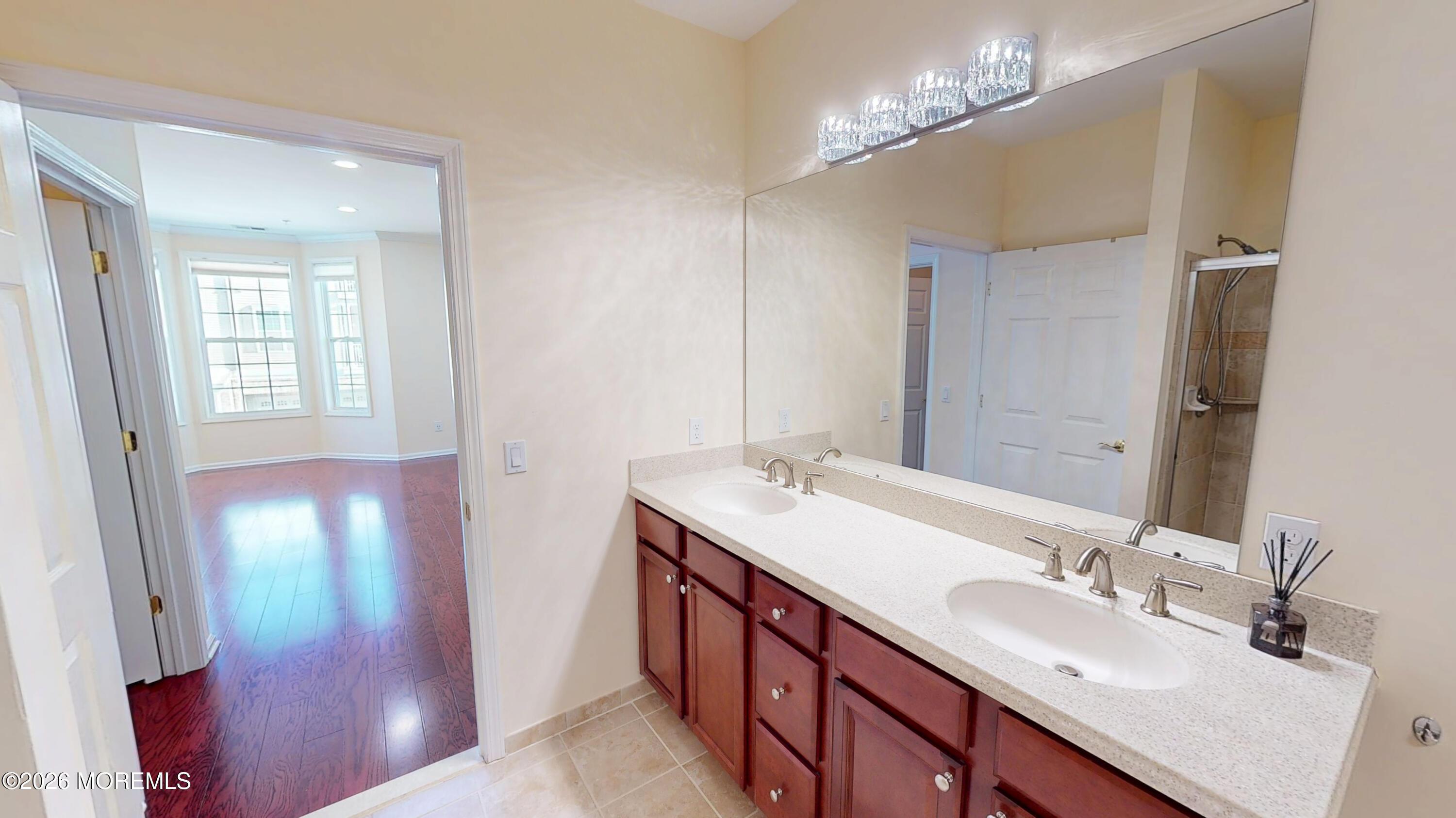 112 Regency Court Morganville, NJ 07751 - Photo 64 of 69 a bathroom with double vanity and a mirror
