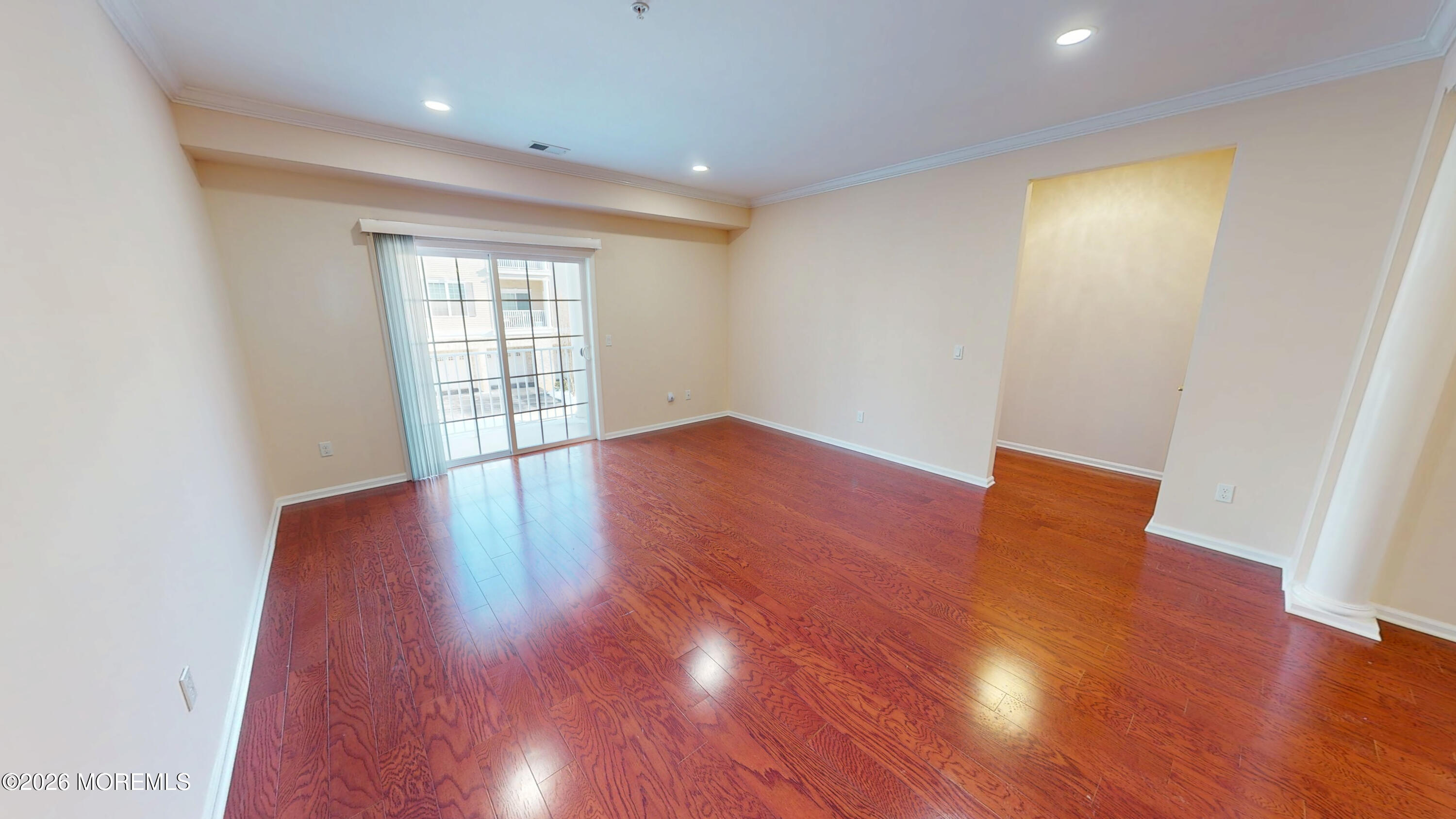 112 Regency Court Morganville, NJ 07751 - Photo 68 of 69 an empty room with wooden floor and windows