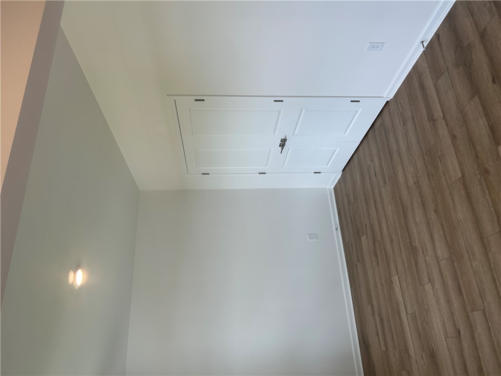 217 Bellflower Lane Anderson, SC 29625 - Photo 5 of 27 Access the attic with a discreetly integrated ceiling door, complementing the rich wood flooring.