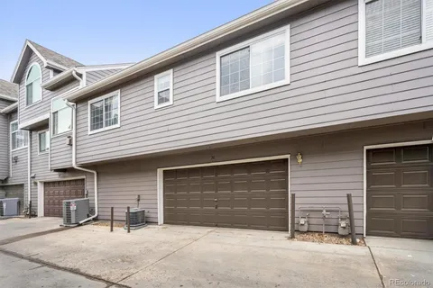 a view of house with outdoor space and parking area
