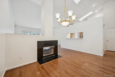 an empty room with wooden floor a fireplace