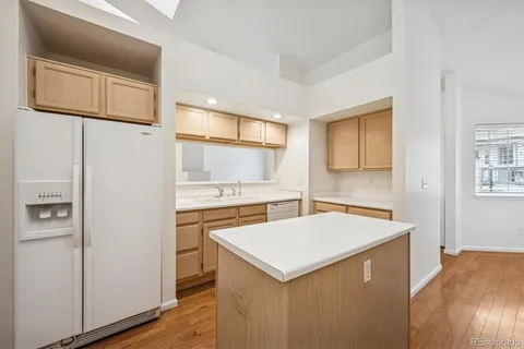 a kitchen with stainless steel appliances a stove refrigerator sink and cabinets