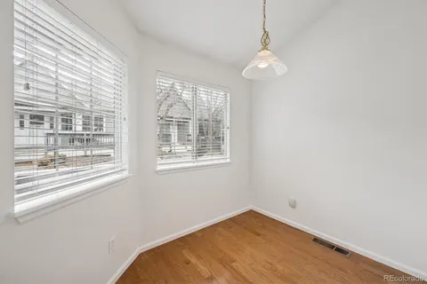 a view of a room with a window and wooden floor