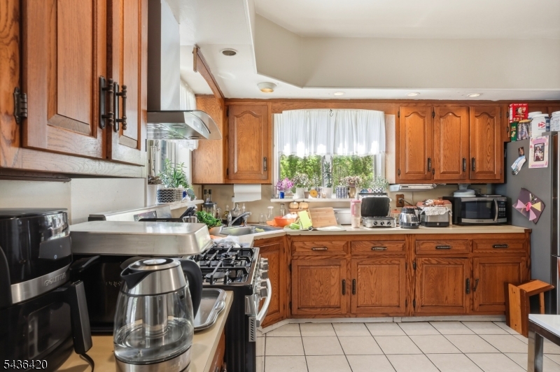 33 Pulaski Place Hackensack, NJ 07601 - Photo 11 of 31 a kitchen with a table chairs sink and cabinets