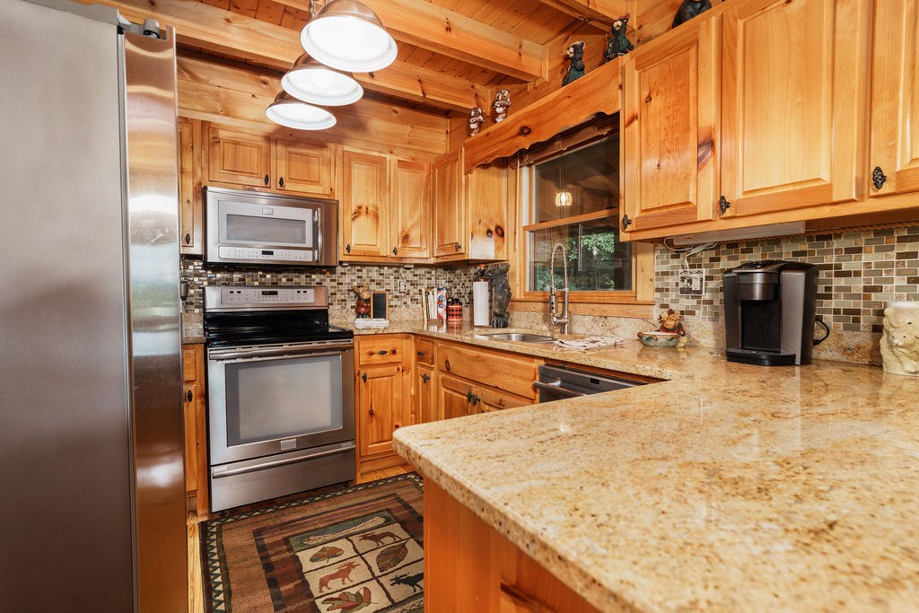 120 Foxfire Road Blue Ridge, GA 30513 - Photo 11 of 55 a kitchen with stainless steel appliances a stove sink and microwave