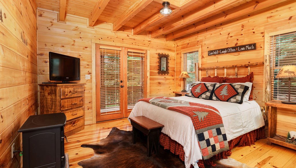 120 Foxfire Road Blue Ridge, GA 30513 - Photo 3 of 55 a bedroom with a bed and wooden floor