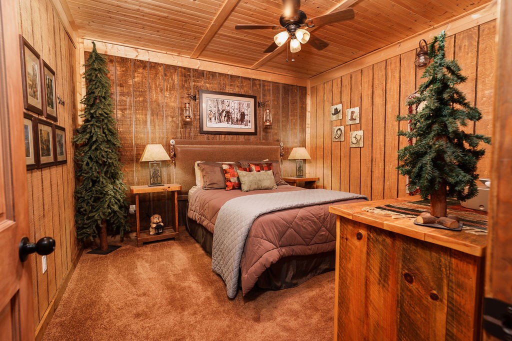 120 Foxfire Road Blue Ridge, GA 30513 - Photo 37 of 55 a bedroom with a bed and a chandelier