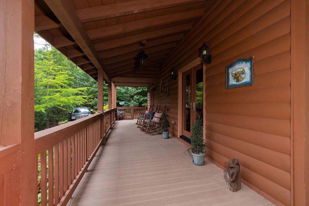 120 Foxfire Road Blue Ridge, GA 30513 - Photo 9 of 55 a view of a porch with wooden floor and roof