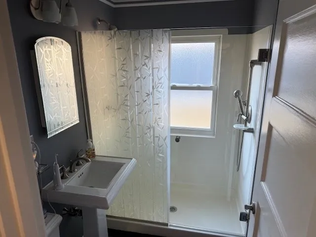 a view of a livingroom and dining room with furniture wooden floor a chandelier