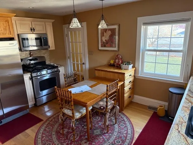 a living room with furniture a flat screen tv and a window