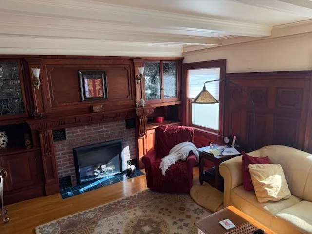 a living room with furniture and a mirror