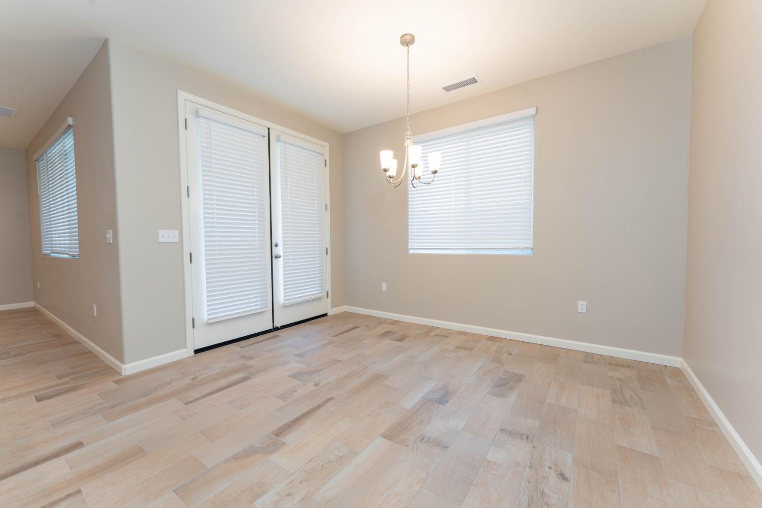 30480 Bellwood Road Visalia, CA 93291 - Photo 27 of 37 an empty room with windows and chandelier fan