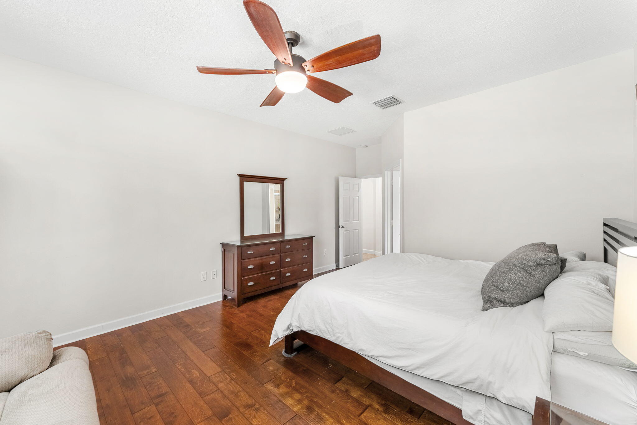 7657 Fieldstone Ranch Square Vero Beach, FL 32967 - Photo 26 of 52 a bedroom with a bed and a dresser