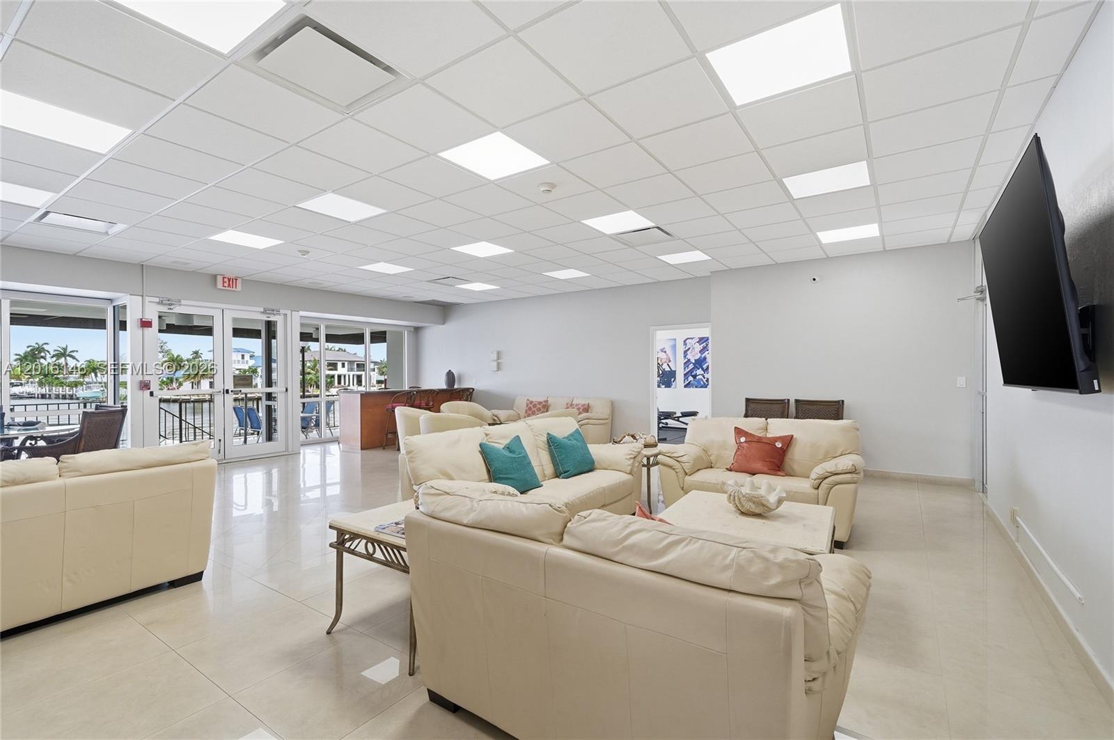 521 North Riverside Drive, Unit 606 Pompano Beach, FL 33062 - Photo 27 of 50 a living room with furniture and a flat screen tv