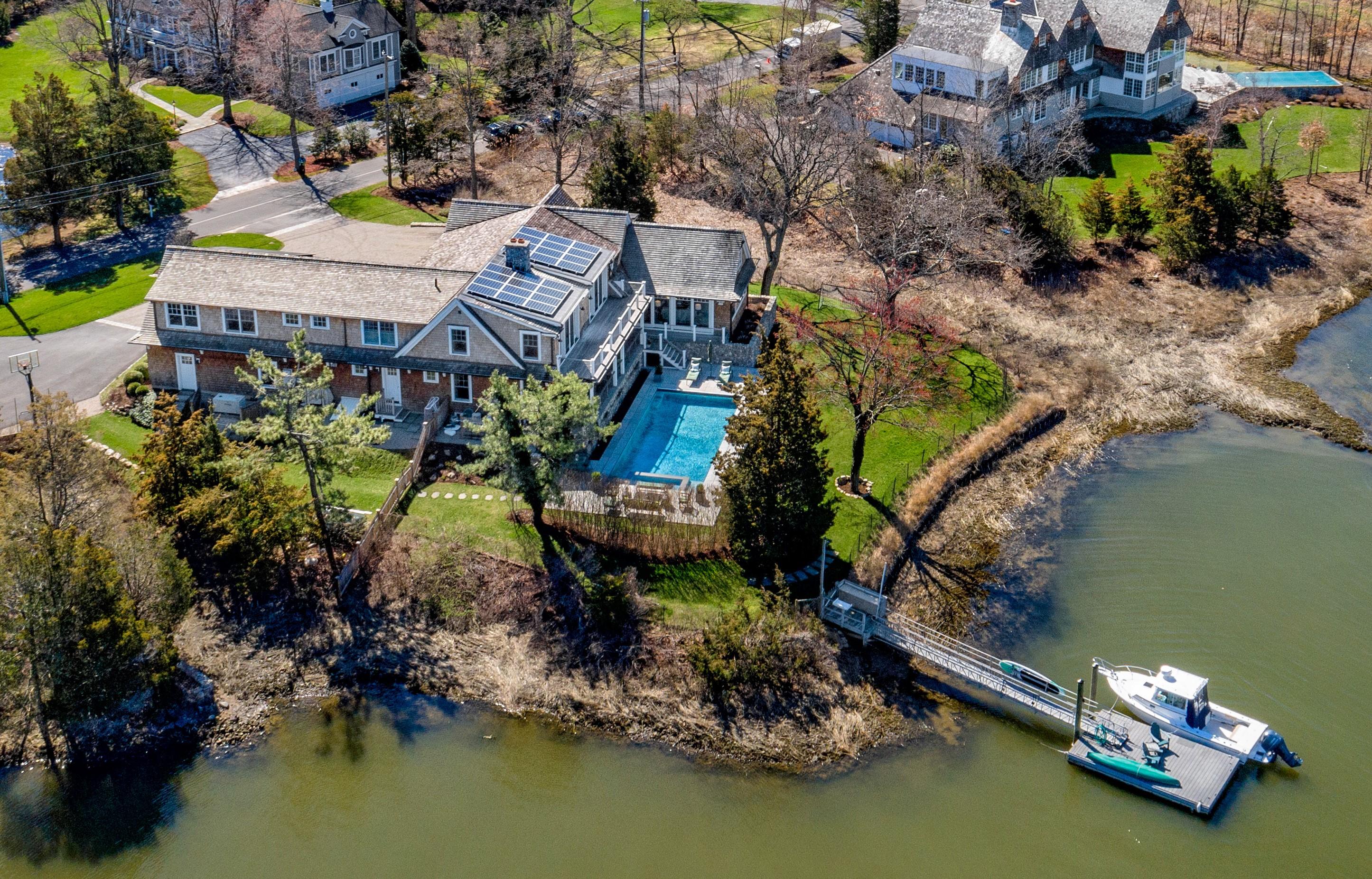 6 Contentment Island Road Darien, CT 06820 - Photo 1 of 40 an aerial view of a house with a lake view