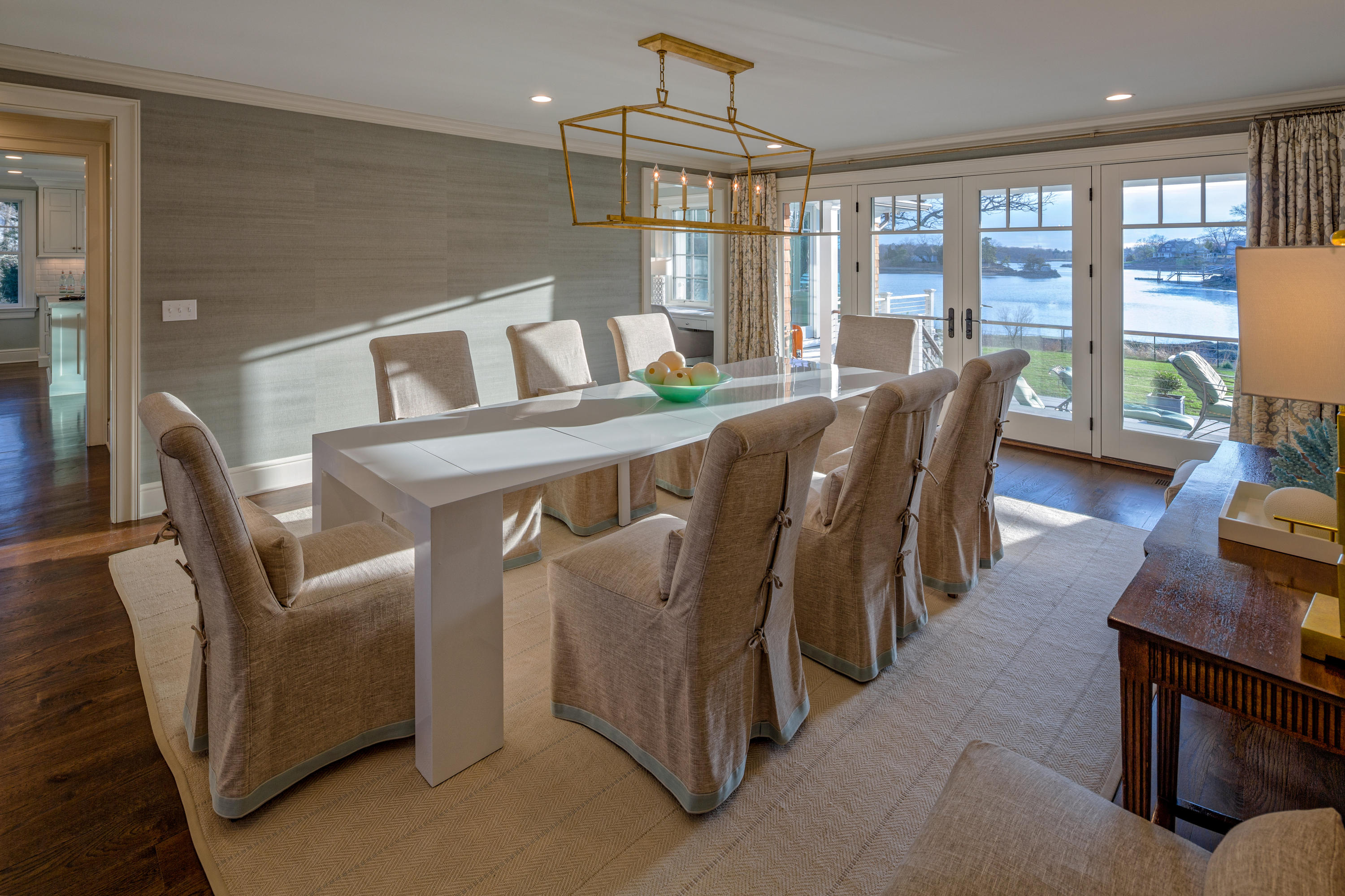 6 Contentment Island Road Darien, CT 06820 - Photo 21 of 40 a view of a dining room with furniture large windows and wooden floor