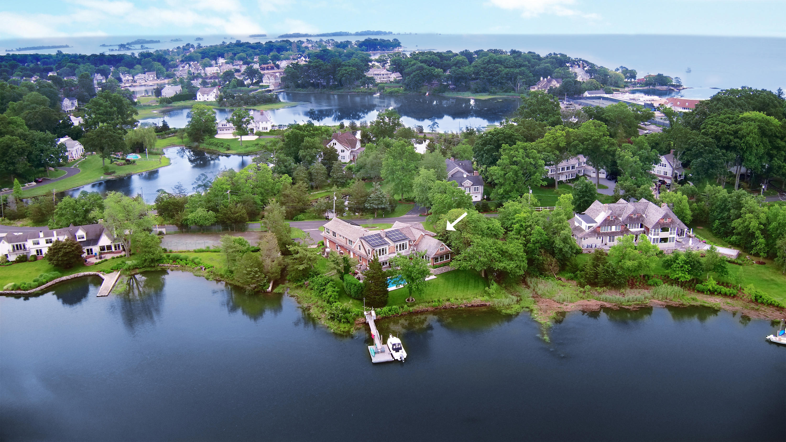 6 Contentment Island Road Darien, CT 06820 - Photo 3 of 40 an aerial view of a house with a garden and lake view