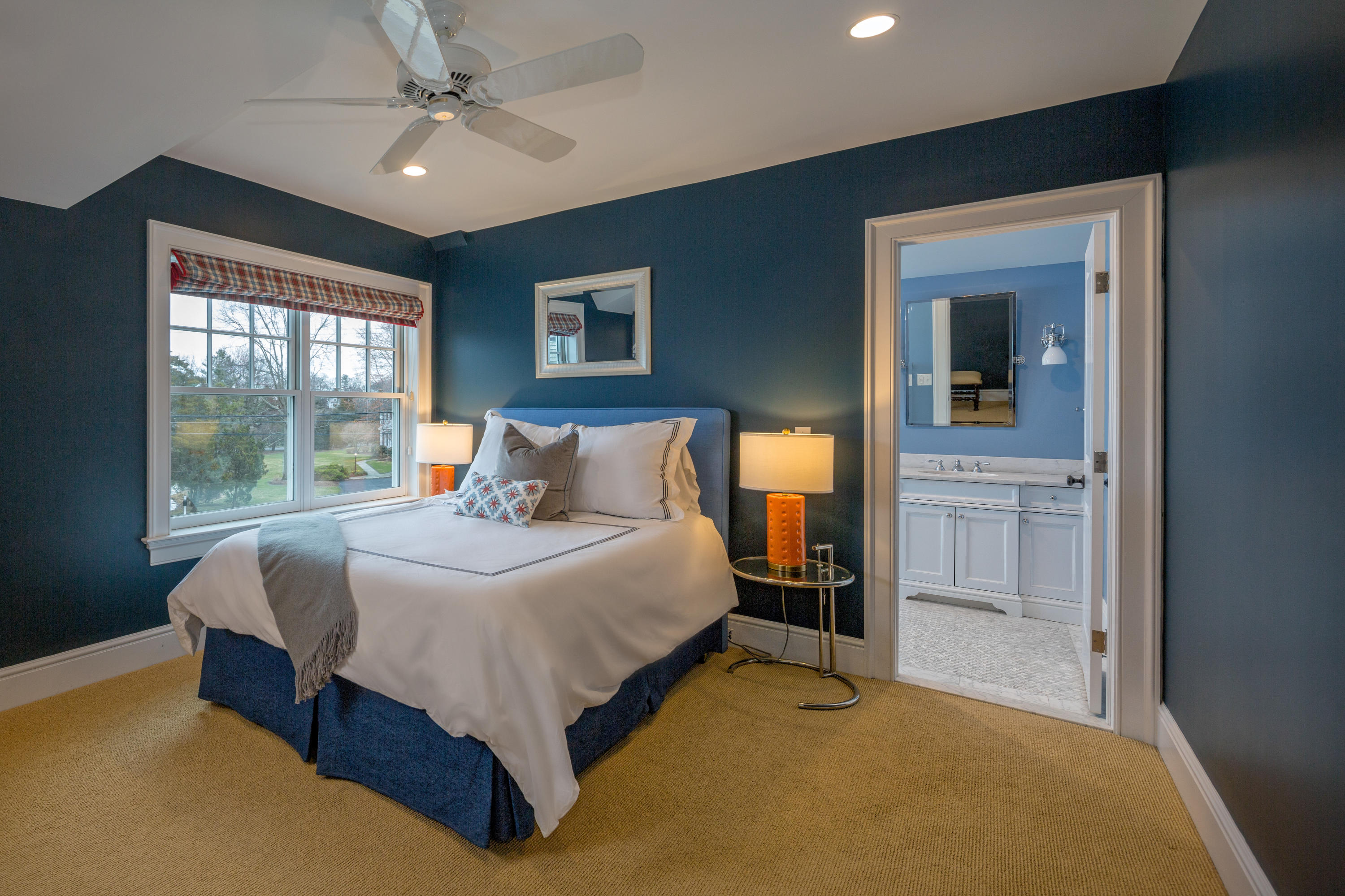 6 Contentment Island Road Darien, CT 06820 - Photo 31 of 40 a bedroom with a large bed and a chandelier