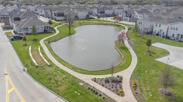 a view of a swimming pool with a garden and plants