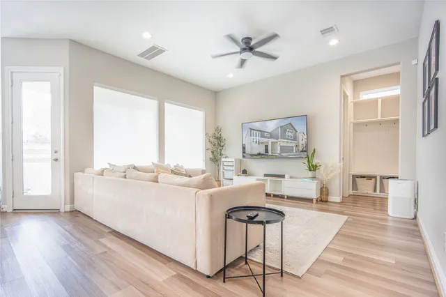 a large white kitchen with cabinets a sink a window and stainless steel appliances