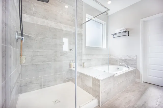 a bathroom with a granite countertop sink a toilet and shower
