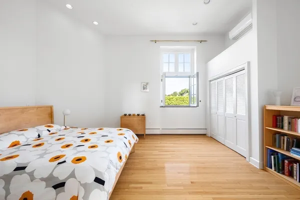 a bedroom with a bed and a book shelf