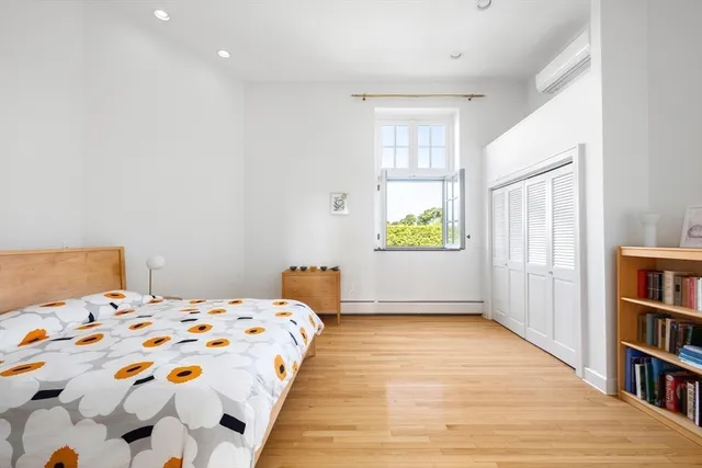 a bedroom with a bed and a book shelf