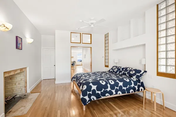 a bedroom with a bed and wooden floor