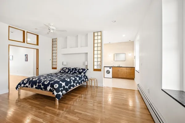 a bedroom with a bed and wooden floor