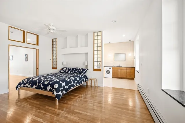 a bedroom with a bed and wooden floor