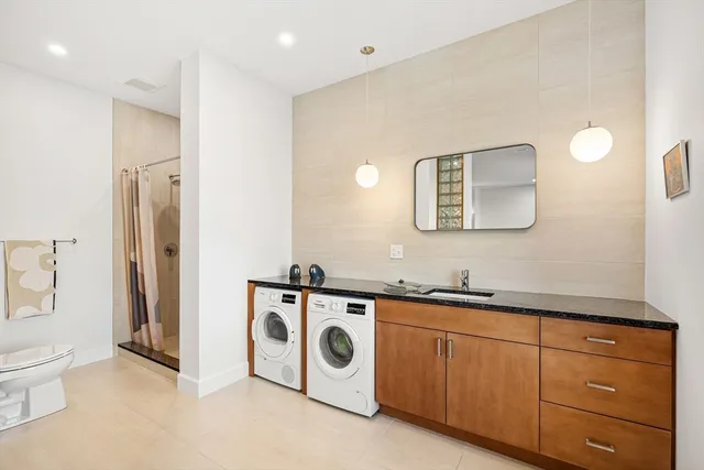 a bathroom with a toilet sink and mirror