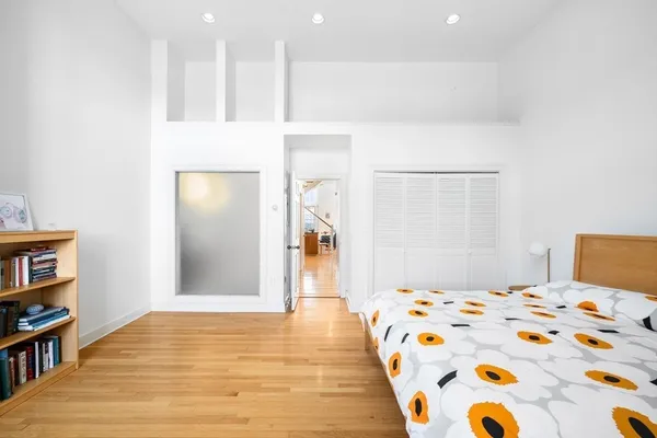a bedroom with a bed and a book shelf
