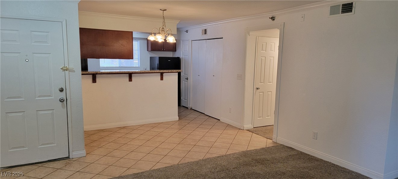 2750 South Durango Drive, Unit 1072 Las Vegas, NV 89117 - Photo 11 of 23 Kitchen with crown molding, light tile patterned f