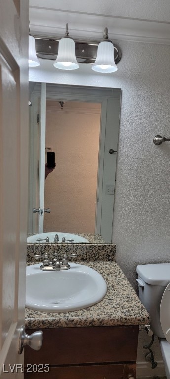 2750 South Durango Drive, Unit 1072 Las Vegas, NV 89117 - Photo 12 of 23 Half bathroom featuring a textured wall and vanity