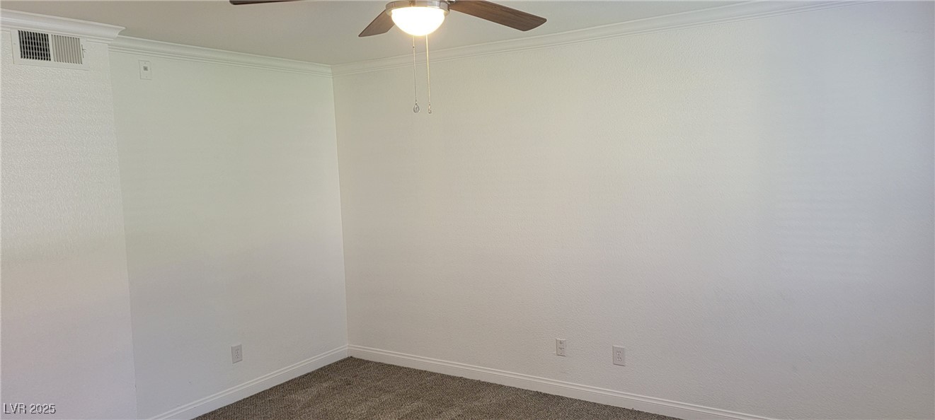 2750 South Durango Drive, Unit 1072 Las Vegas, NV 89117 - Photo 16 of 23 Carpeted spare room featuring ceiling fan and orna