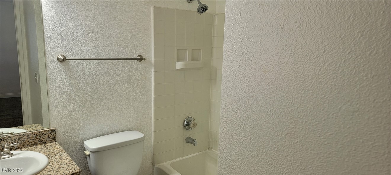 2750 South Durango Drive, Unit 1072 Las Vegas, NV 89117 - Photo 18 of 23 Full bathroom with a textured wall, bathing tub /