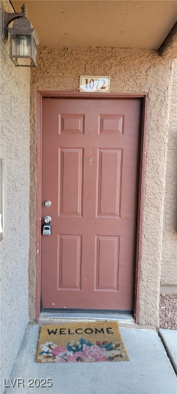 2750 South Durango Drive, Unit 1072 Las Vegas, NV 89117 - Photo 2 of 23 Doorway to property featuring stucco siding
