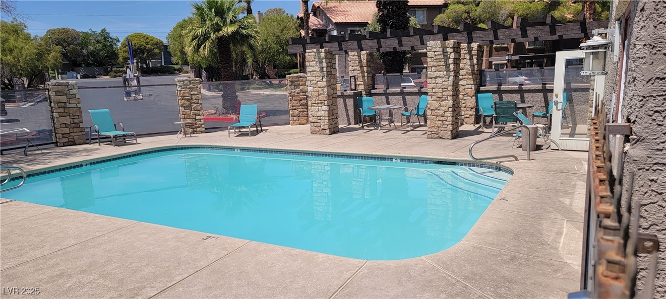 2750 South Durango Drive, Unit 1072 Las Vegas, NV 89117 - Photo 23 of 23 Community pool with a patio and a pergola