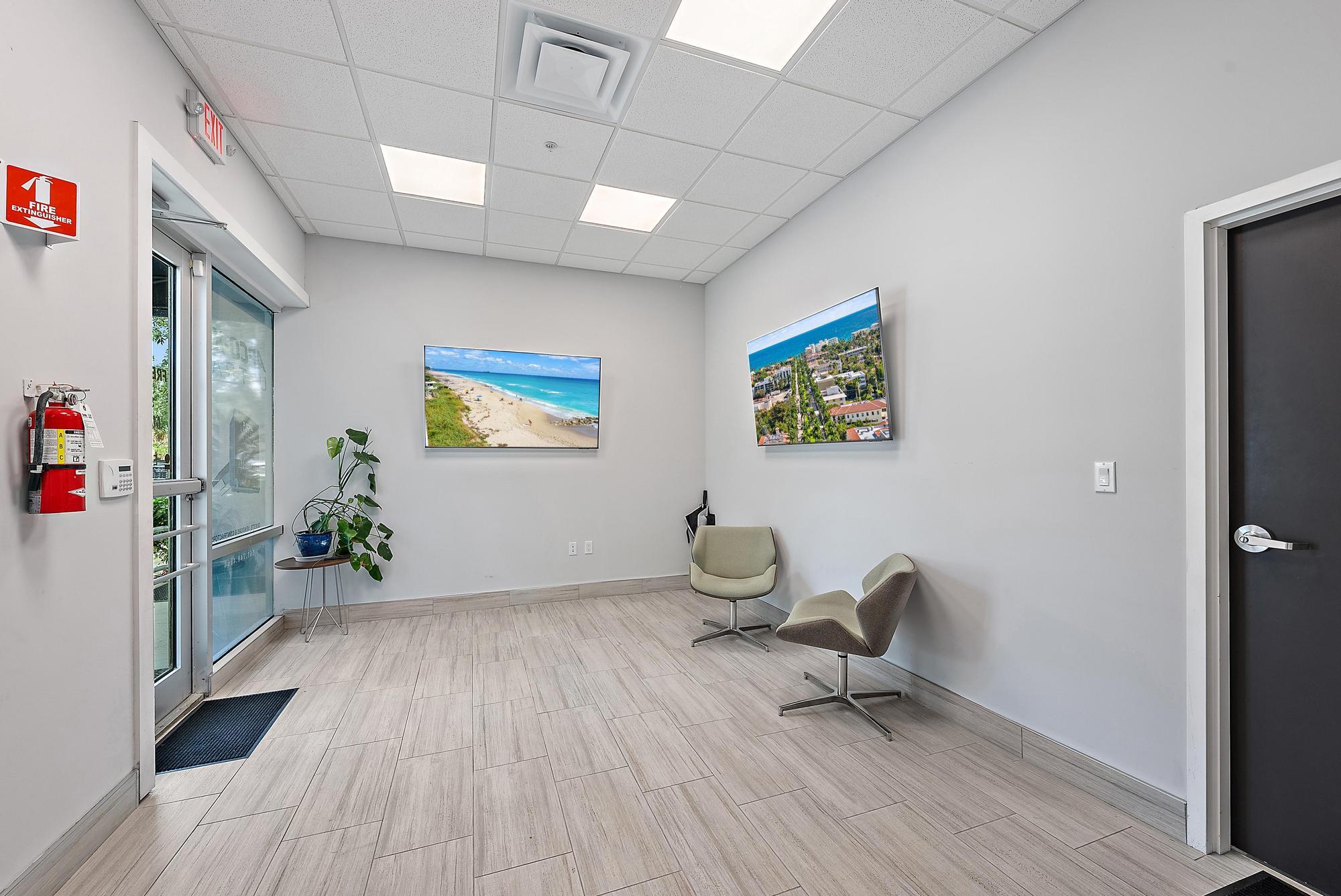 3126 Jupiter Park Drive Jupiter, FL 33458 - Photo 12 of 34 a workspace with furniture and wooden floor