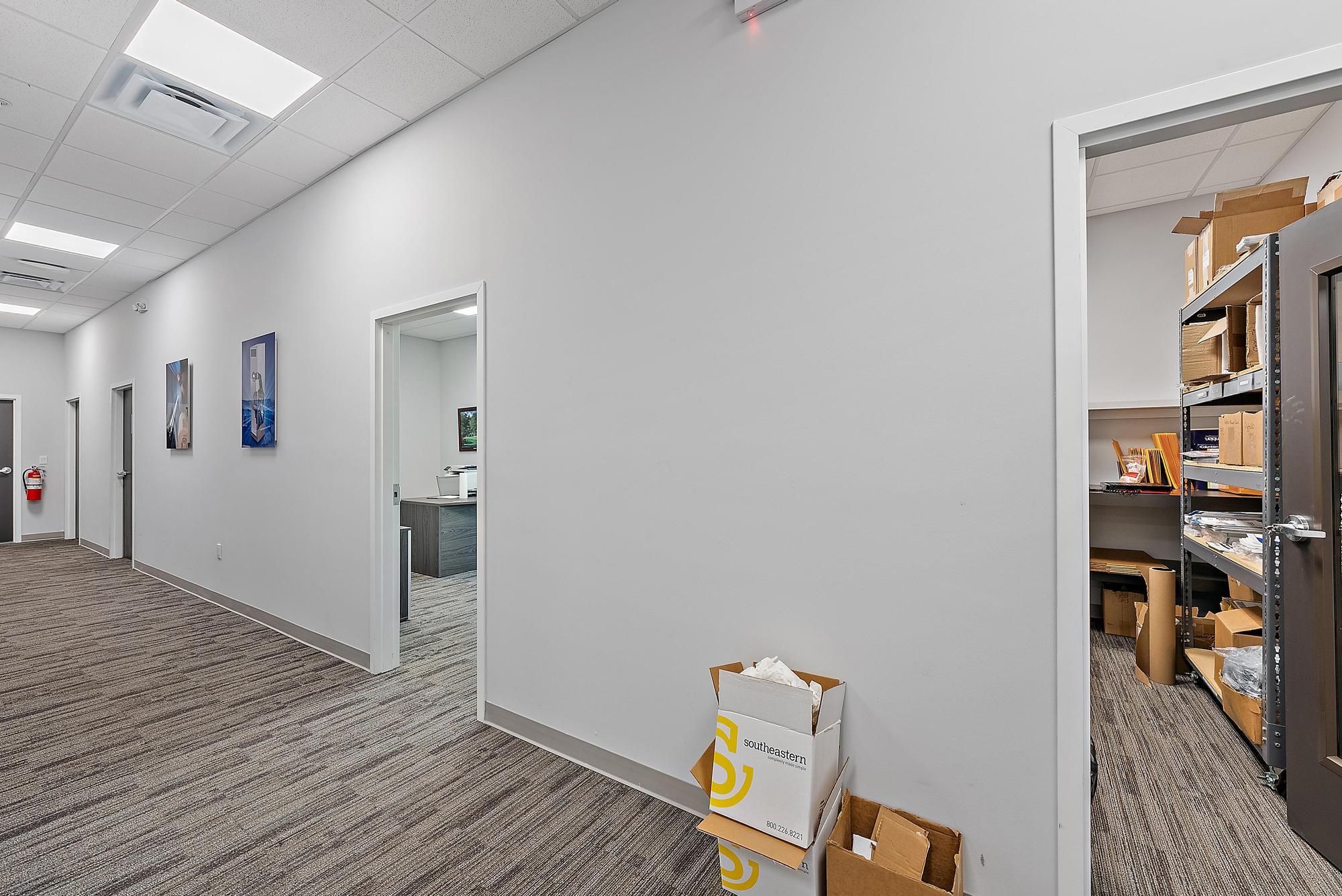 3126 Jupiter Park Drive Jupiter, FL 33458 - Photo 16 of 34 a view of a hallway with wooden floor and a bathroom